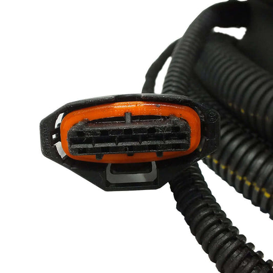 Close-up of an electrical connector used in hydraulic systems, showcasing its orange detailing and wiring.